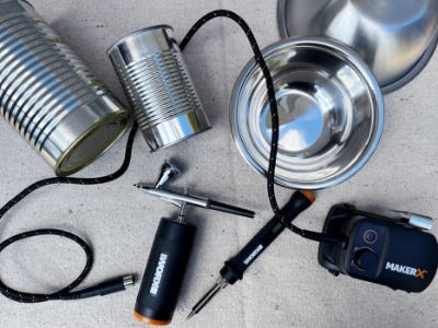 metal cans and bowls next to air brush and metal crafter