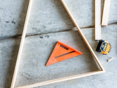 wooden pieces cut to make the shape of a large triangle