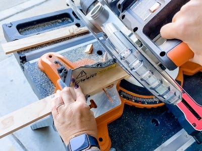 image of person using the Miter saw to cut wood