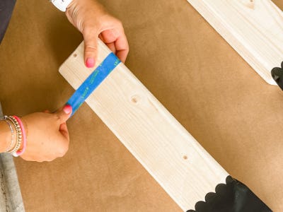 adding blue stencil to corner of wood