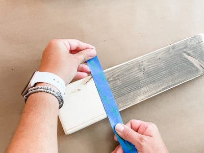 applying blue masking tape between stained and non stained area