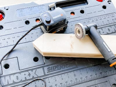 angle grinder sitting on top of wood tipped piece