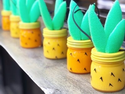 multiple yellow green pineapple jars placed on top of table