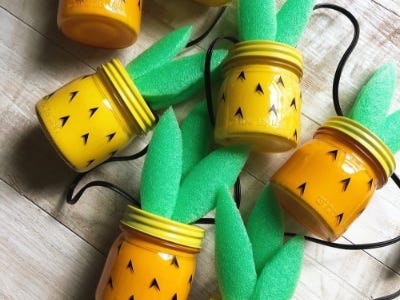 5 pineapple jars laying side down next to each other on table