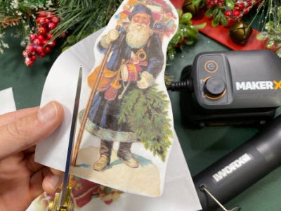 using scissors to cut around santa image