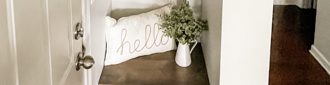 DIY buil-in shelf plank wall holding pillow and plant vase