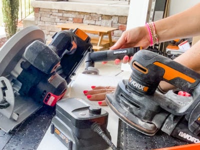 using angle grinder to cut the edge into wood 