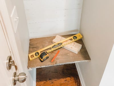 wood shelf hanging from inside of cubby