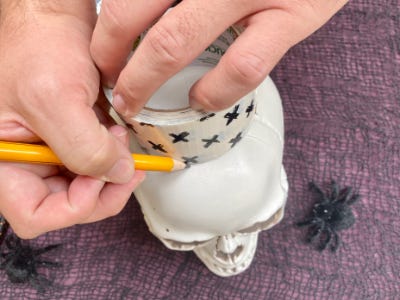 using pencil to mark around tape on top skull