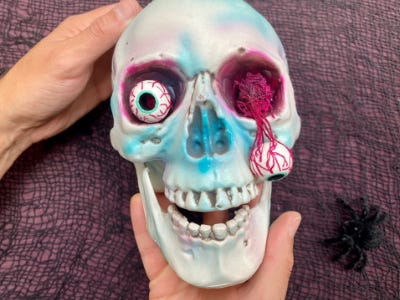 skull with eye ball falling out of it