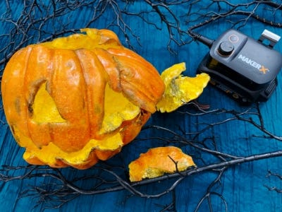 smashed pumpkin on blue cloth and sticks