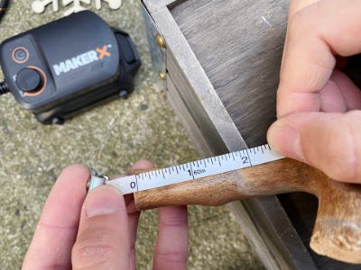 using measure tape to measure stick