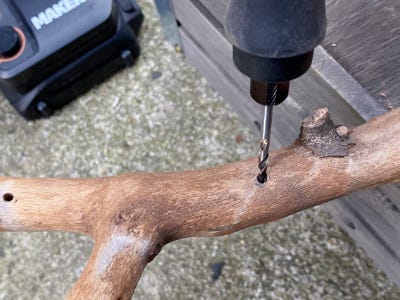 using drill to drill into stick