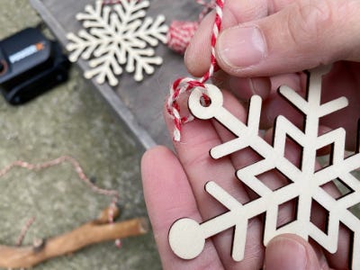 threading red and white through top of snowflake