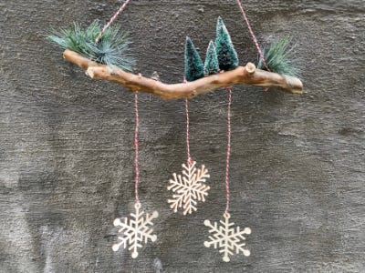 Snowflakes hanging from branch from wall