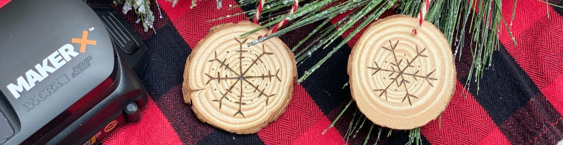 wooden snowflake ornaments on red and black plaid cloth