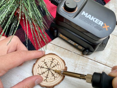 finishing the snowflake using wood burning tool trace over pencil stencil 