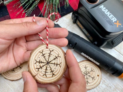 threading red and white twine into hole