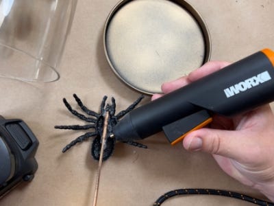 gluing stick to bottom of fake spider