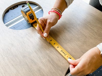 using measuring tape to measure from bottom of whole to edge