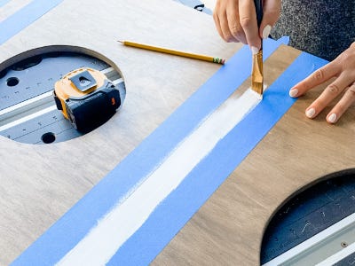 painting the color white between blue painter tape