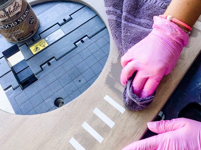 using towel to apply stain over white painted stripes