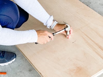 nailing a nail into middle of plywood