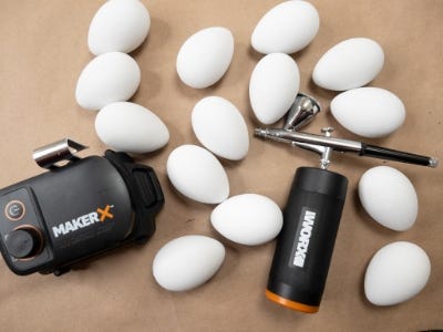 eggs laid out on a table net to the makerx air bursh and hubx units