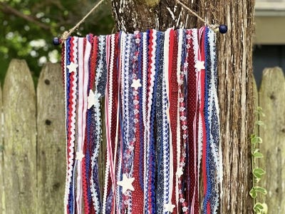 Fabric wooven cloth with stars on it hanging from tree 