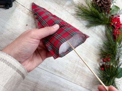 sticking skewer into foam wrapped plaid tree