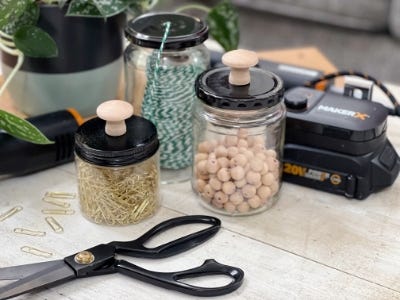 two jars filled next to scissors and batter charger