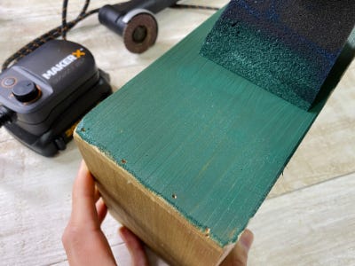 green acrylic paint being applied to side of wood box