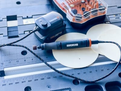 rotary tool sitting on top of wood circle thats on worktable pegasus