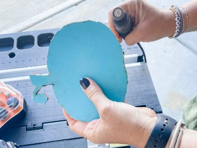 using the sanding rotary tool on the edges of pumpkin wood template