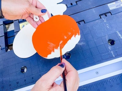 painting the orange pumpkin wood block