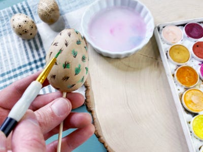 Painting wood burned egg with green color