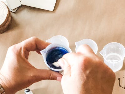 Blue color being mixed inside pouring cup