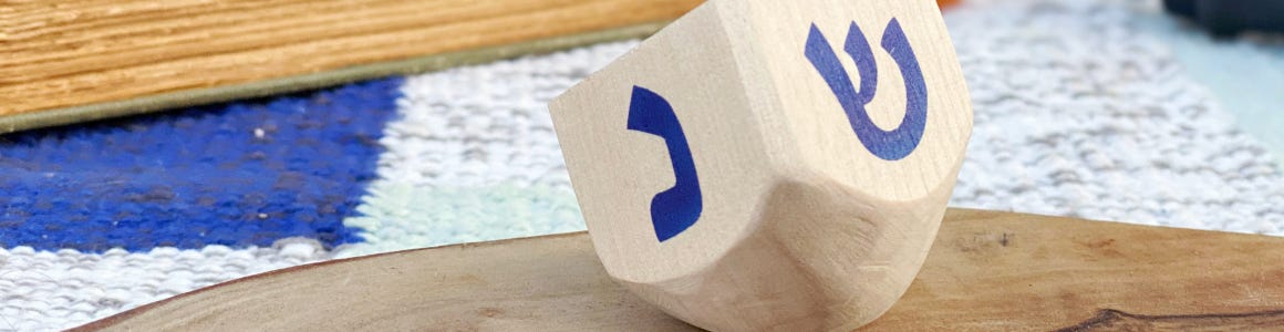 wooden dreidel sitting on table