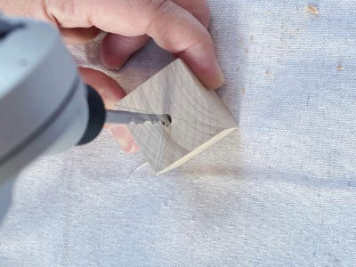 drilling a hole into the top of the wood block