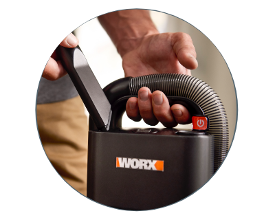 person holding and wrapping the hose around the vacuum