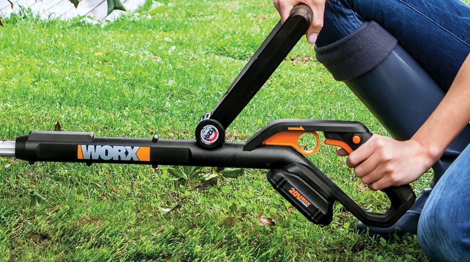 person holding a worx trimmer with the power share battery attached