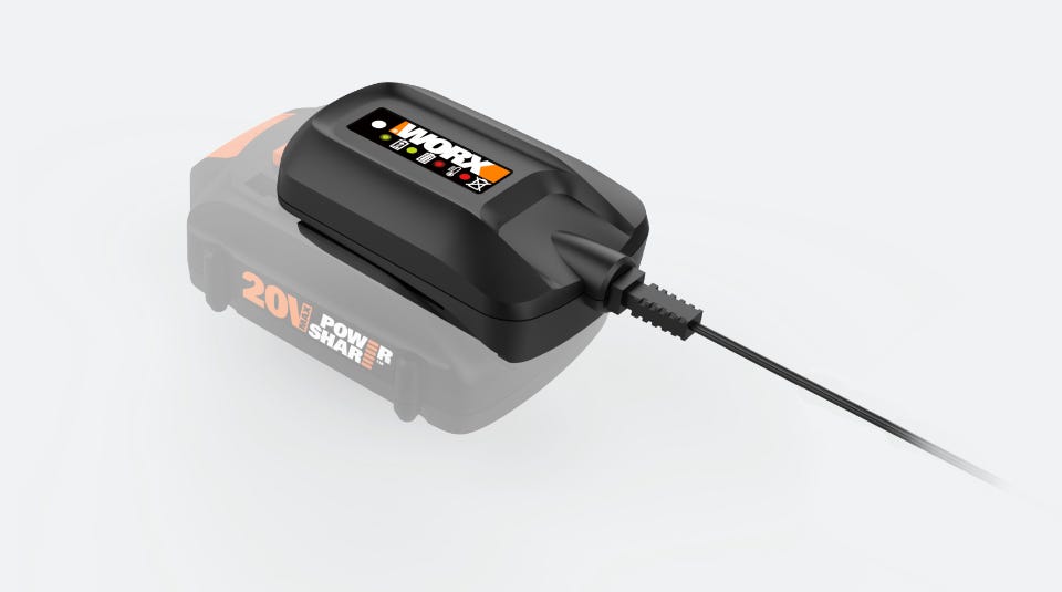 image of the charger on a gray background with the battery it is connected to blurred out