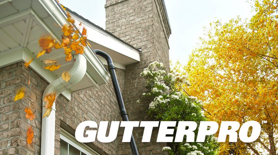 person using the assembled gutter pro on the gutter on the side of their house