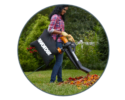 woman using trivac to vacuum up leaves in the yard