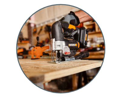 person using the jigsaw to cut into wood