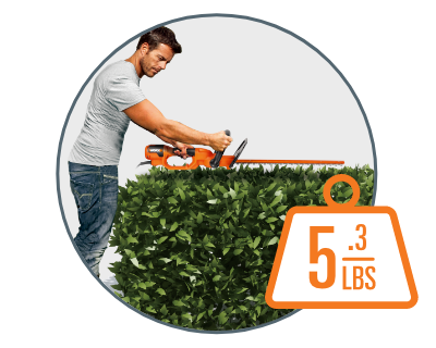 man using the trimmer to cut a hedge