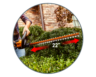 person holding the hedge trimmer in front of a hedge and an arrow showing it is 22 inches long