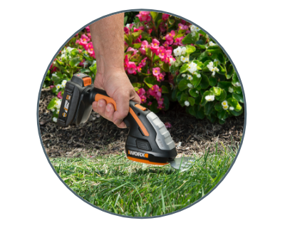 person using the shrubber on grass