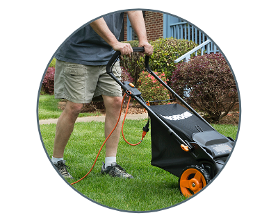 man pushing the mower in a yard