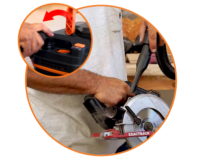 person connecting the vacuum to a saw to blow away the debris